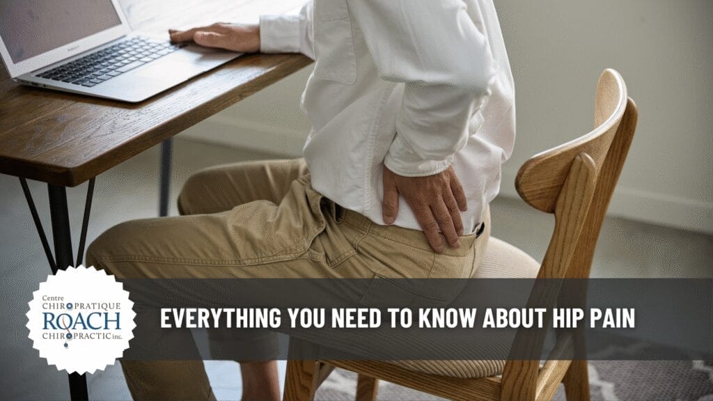 Everything You Need to Know About Hip Pain 2 a person sitting at a desk holding their hip in pain.