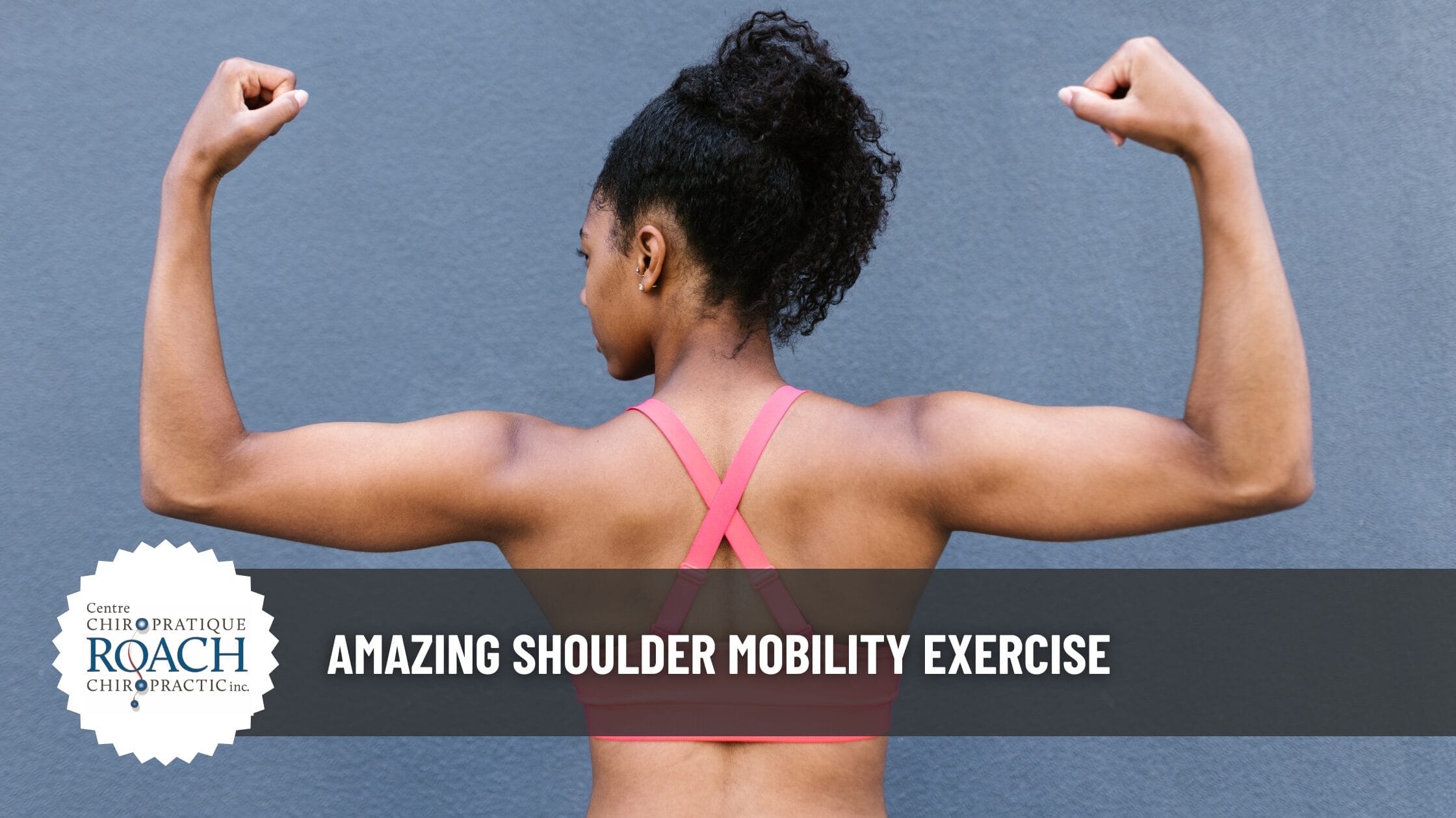 woman posing to display a chiropractic wall angle shoulder exercise.