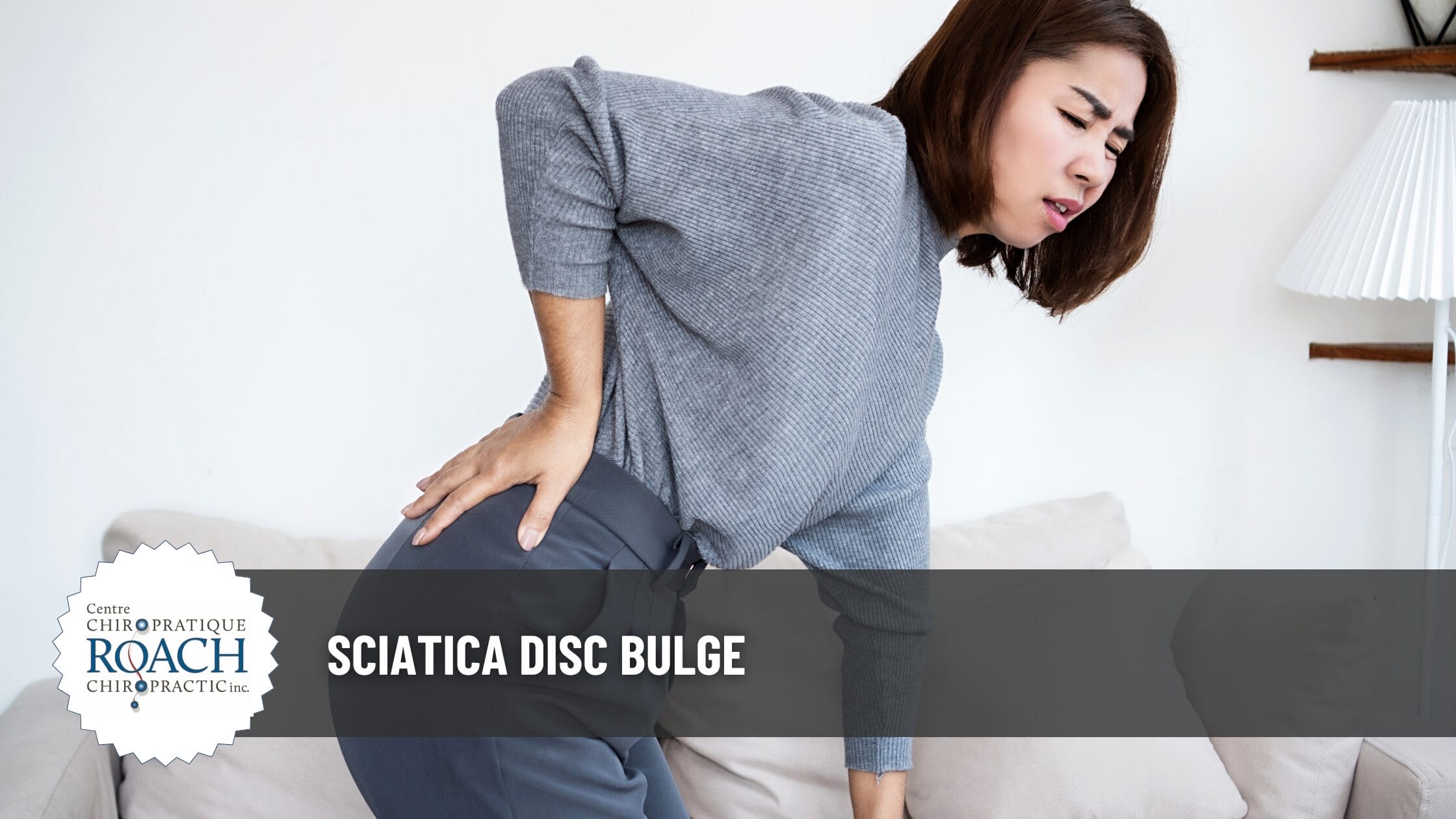 a woman holding her sciatic nerve area experiencing sciatica disc bulge.