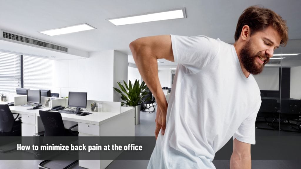How to minimize back pain at the office 6 a man in a white shirt with back pain at the office